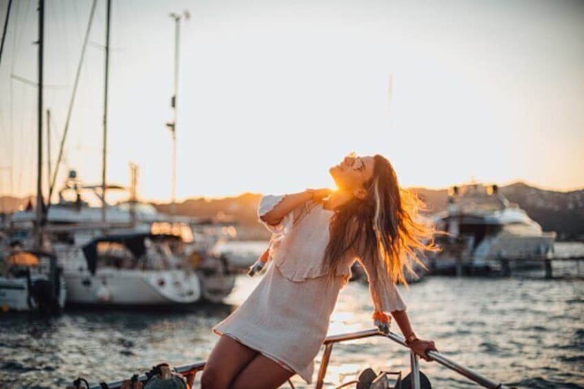 A person on a boat with a sunset in the background. 4