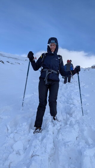A person skiing on a snowy mountain with a clear sky. 5
