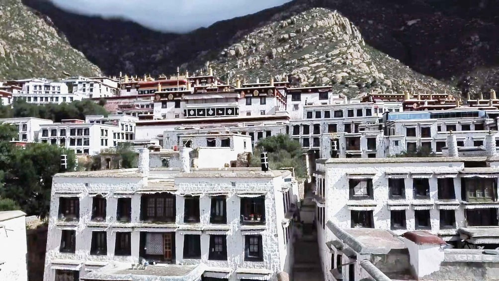 A mountainous village with traditional buildings and a prominent temple. 2