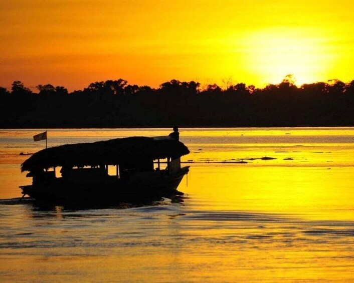 A boat with a flag on a river at sunset. 4