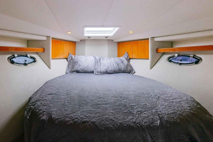 A bedroom with a large bed, two windows, and wooden headboards. 5