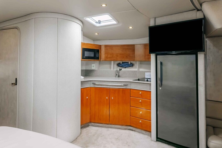 A compact kitchen with a microwave, sink, and refrigerator. 4