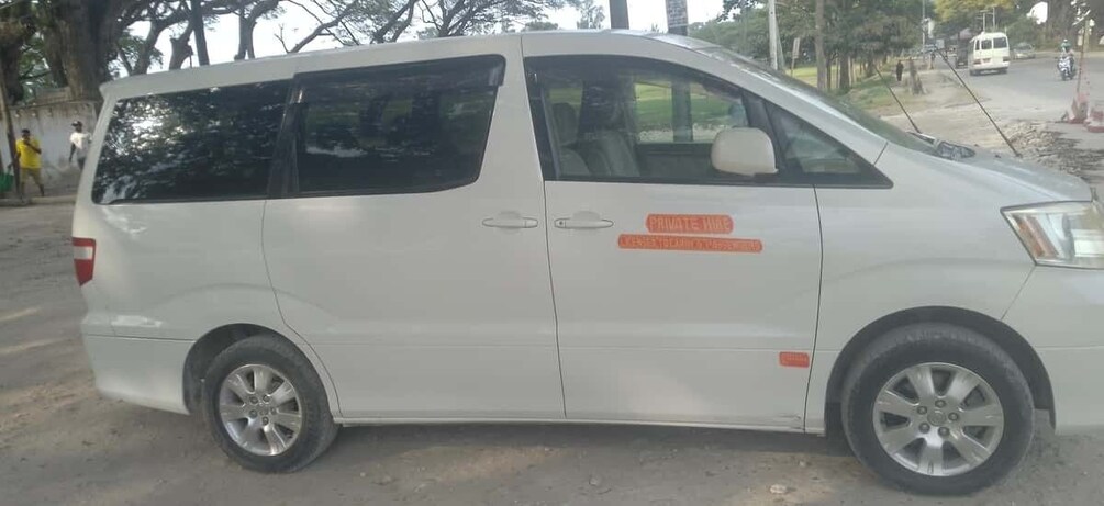 A white van parked on a street with a 'PRIVATE HOUSE' sign on its side. 3