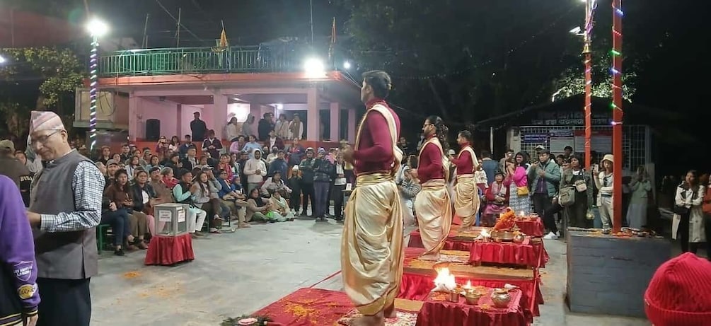 A group of people in traditional attire performing in front of an audience at an outdoor event. 5