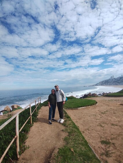 A coastal path with a view of the ocean and a rocky shoreline. 3