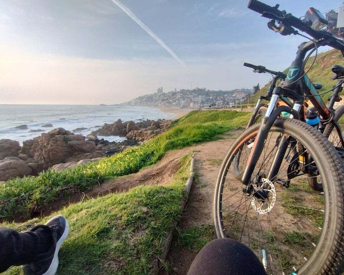 A mountain bike on a trail with a coastal view. 1