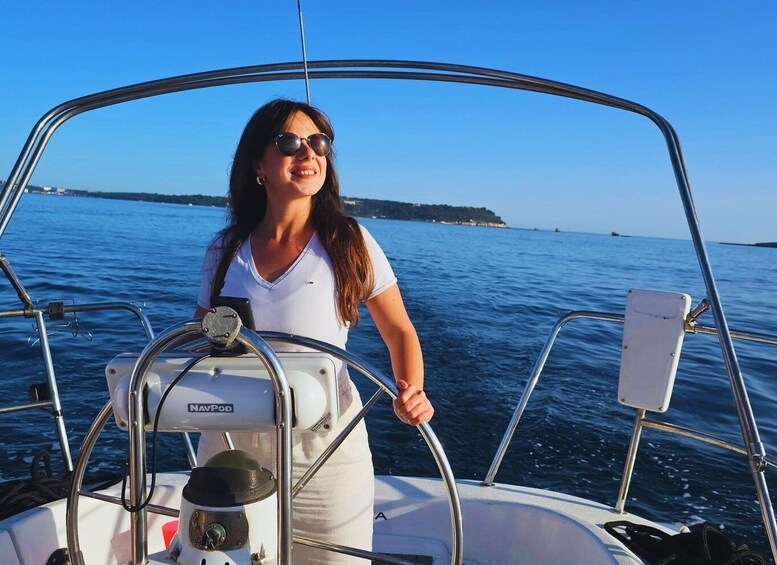 A person on a boat with a clear view of the water and a distant shoreline. 2