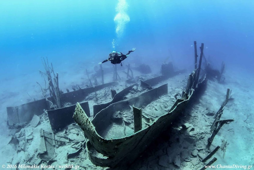 A diver exploring an underwater shipwreck. 1