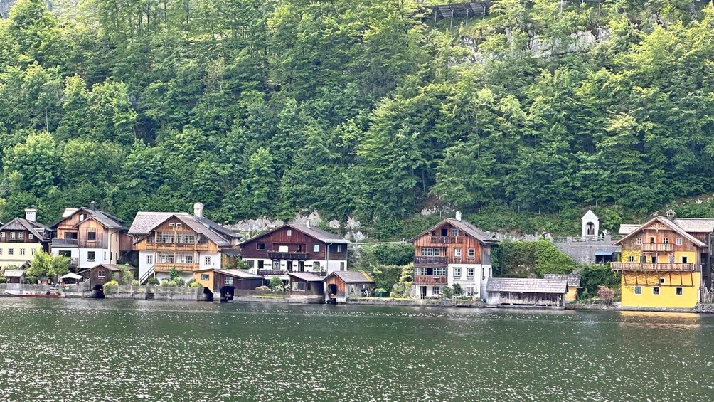 A lakeside village with wooden houses and a church. 2