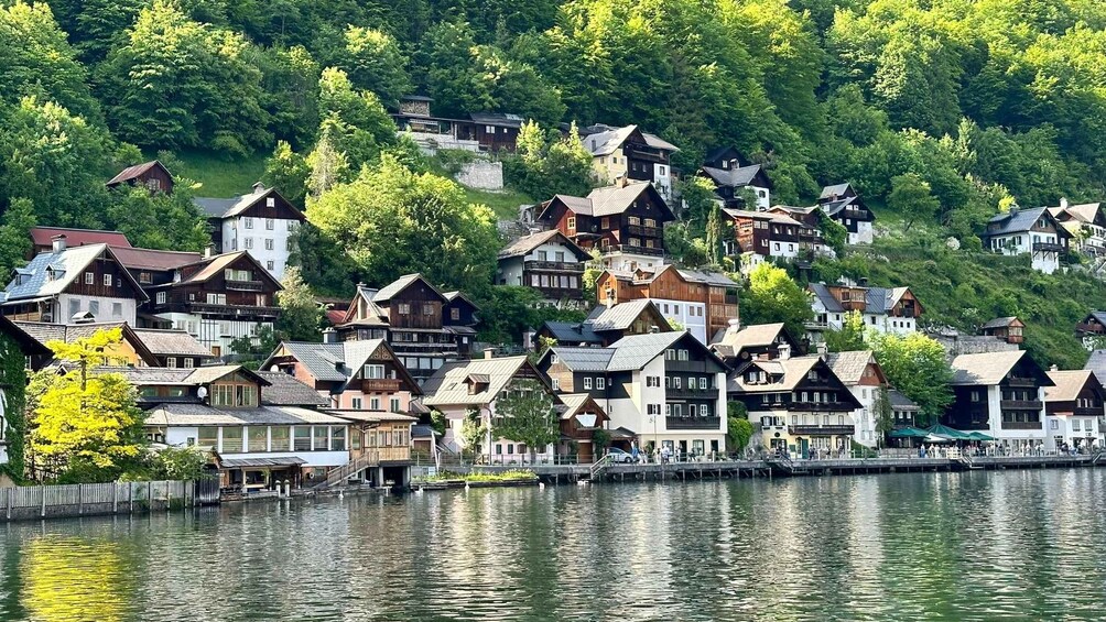 A lakeside village with traditional wooden houses and a dock. 1