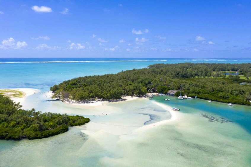 A tropical island with clear turquoise waters, sandy beaches, and dense green forests. 5