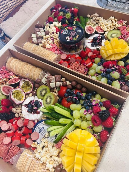 A box filled with various snacks and fruits. 4