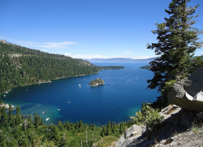 A lake surrounded by dense forests and rocky terrain. 1