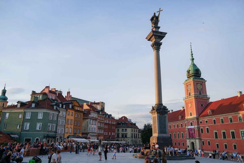 A bustling square with a tall column, historic buildings, and a clock tower. 4