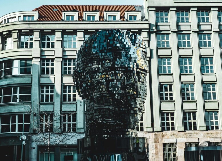 A modern building with a unique spherical sculpture in front. 2