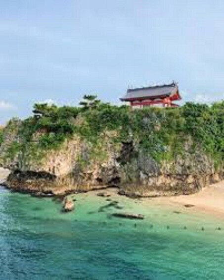 A traditional building on a cliff overlooking turquoise waters. 5