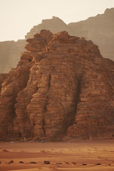 A large rock formation in a desert landscape. 5