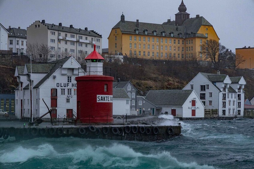 A red lighthouse, white buildings, and a yellow castle by the sea. 3