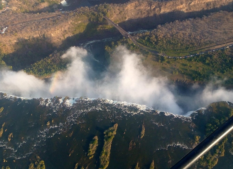A river flowing through a valley with a bridge and a road. 5