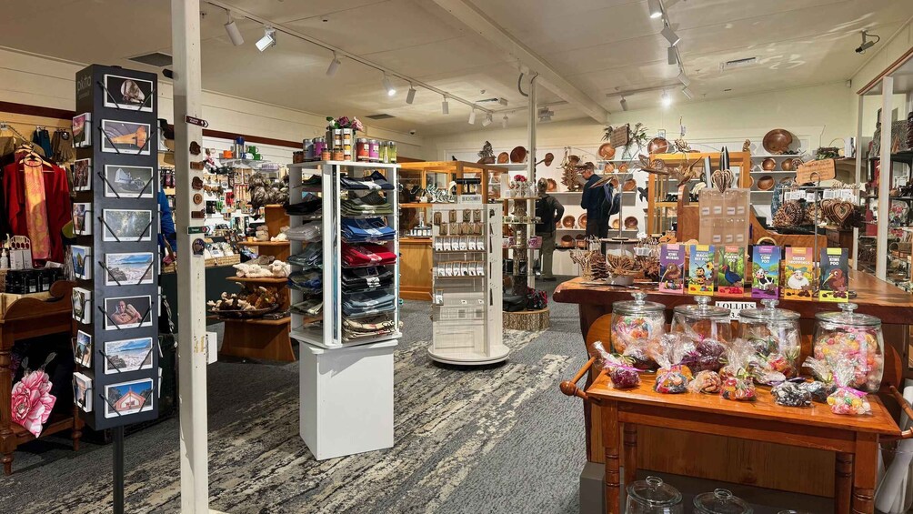 A gift shop with various items on display including postcards, bags, and souvenirs. 5