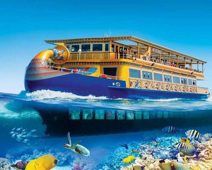 A colorful boat with a golden funnel and a blue hull, floating on water with a coral reef and various fish. 1