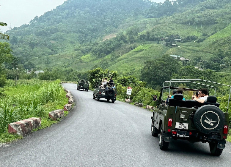 A winding road with vehicles and passengers. 3