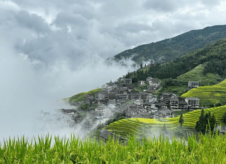 A terraced village with traditional architecture nestled in a mountainous landscape. 5