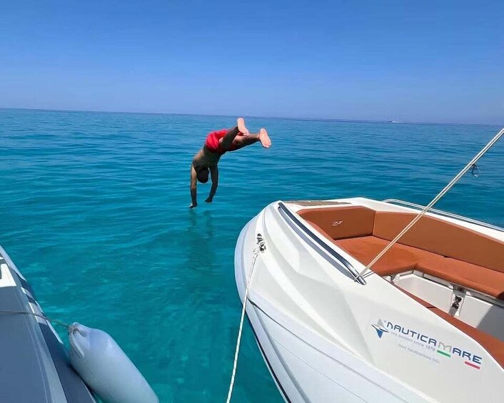 A person diving into the water from a boat. 1