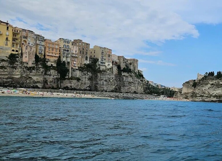A coastal town with buildings on a cliff overlooking the sea. 4