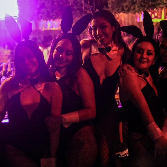 A group of people in bunny ears and formal attire at an event. 4