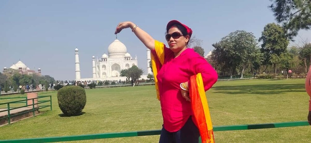 A person in a park with the Taj Mahal in the background. 1