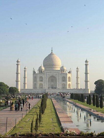 The Taj Mahal with four minarets, a large central dome, and a reflection pool. 5