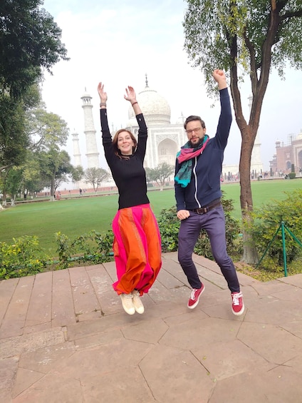 Two people jumping in front of the Taj Mahal. 3