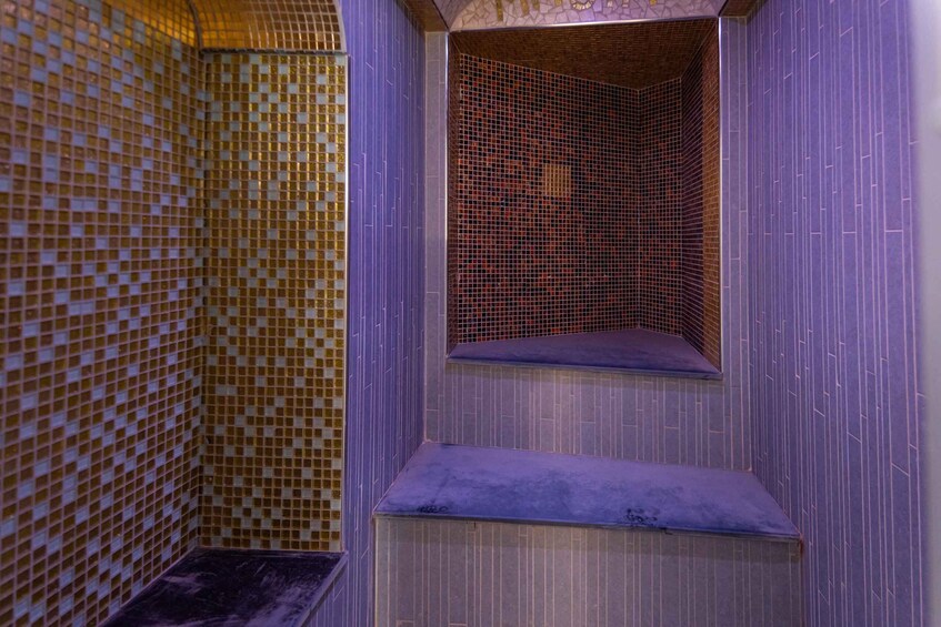 A tiled wall with a small window. 3