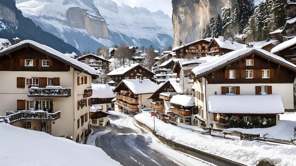A snow-covered village with wooden houses, a winding road, and mountains in the background. 2
