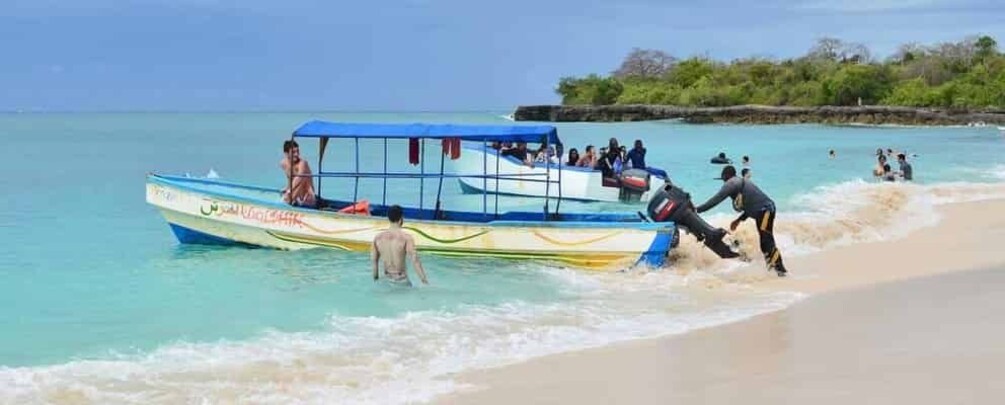 A boat with people on a beach. 1