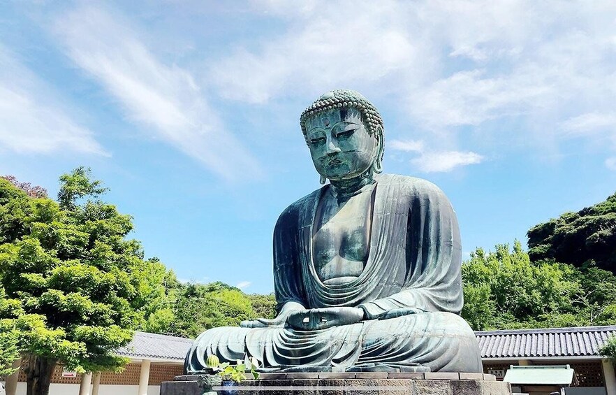 A large Buddha statue in a serene outdoor setting. 1