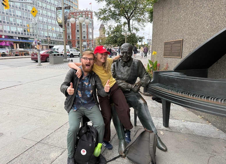 A statue of a man playing a piano, a street with cars, and a building with a red facade. 2
