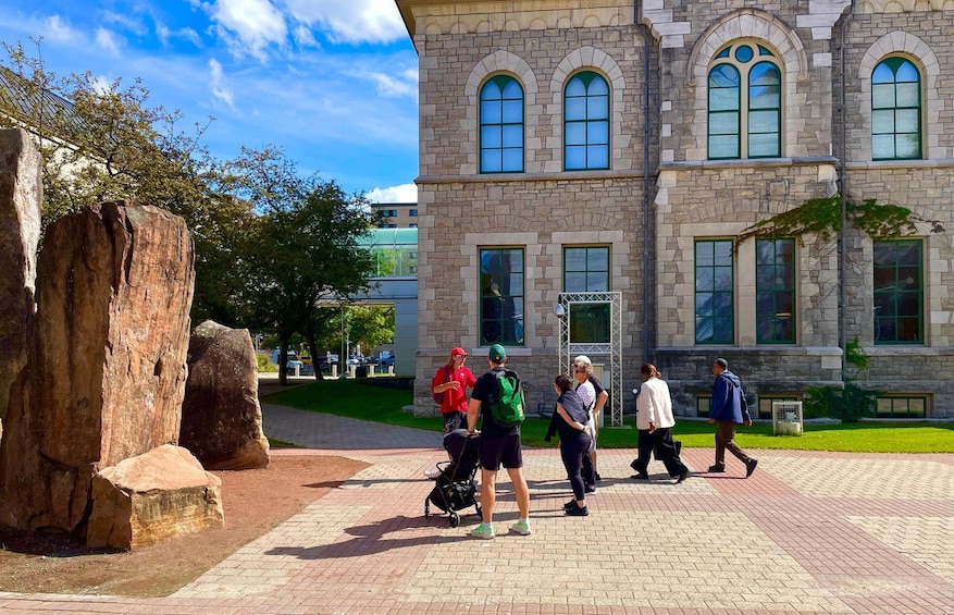 A stone building with arched windows and a paved walkway. 2