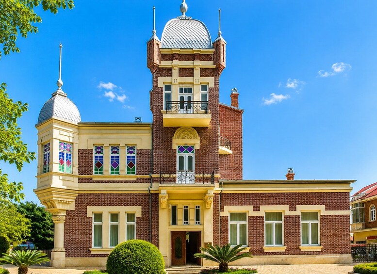 A large, ornate building with a central tower, multiple windows, and a dome. 3