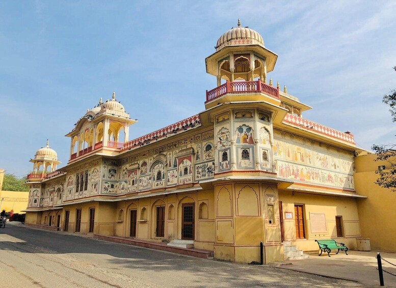 A historic building with ornate murals and domes. 5