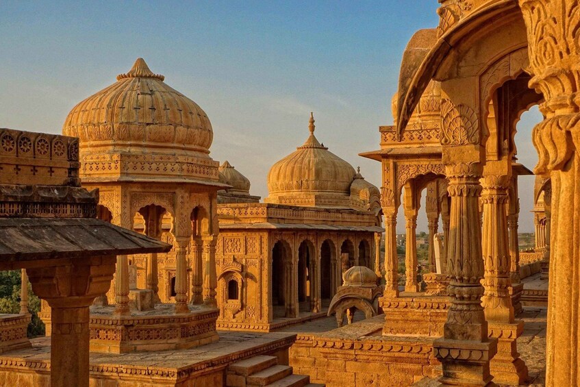 A historical building with domed structures and intricate carvings. 1