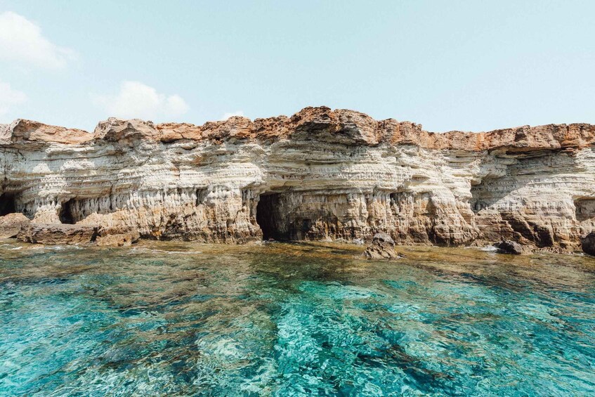 A coastal cliff with clear turquoise water in front. 4