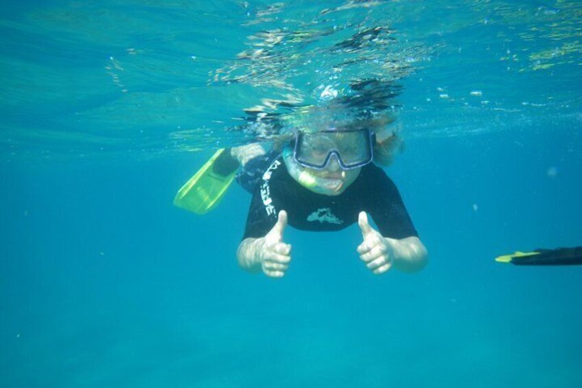 A person underwater giving a thumbs-up. 4