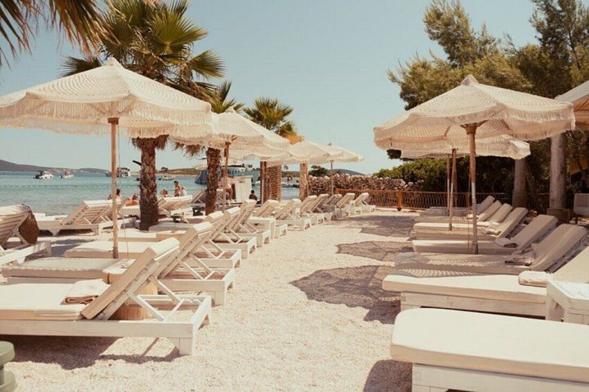 A beach with sun loungers and umbrellas. 2