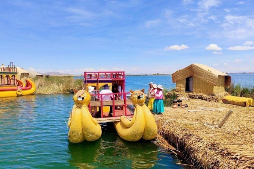 A yellow boat with passengers, a small wooden structure, and a river. 2