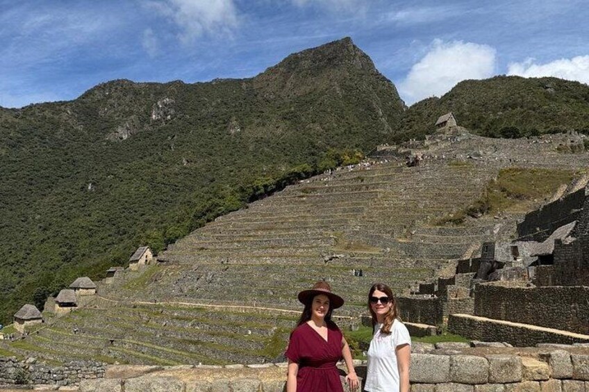 A historical site with terraced steps and ruins, surrounded by mountains. 3