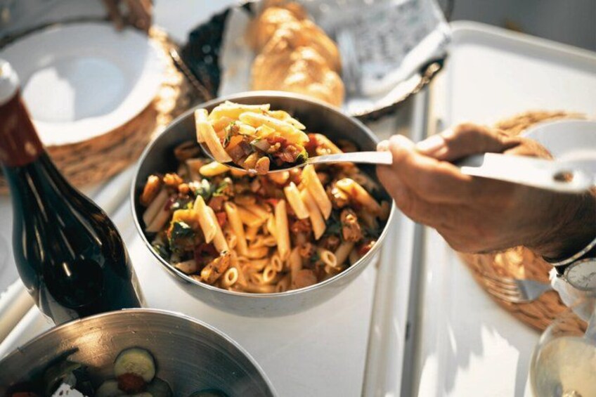 Et måltid med pasta og en flaske vin på et bord. 3
