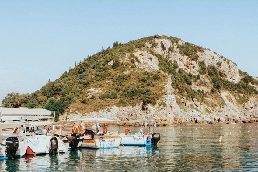 Boats docked near a rocky hill with sparse vegetation. 4