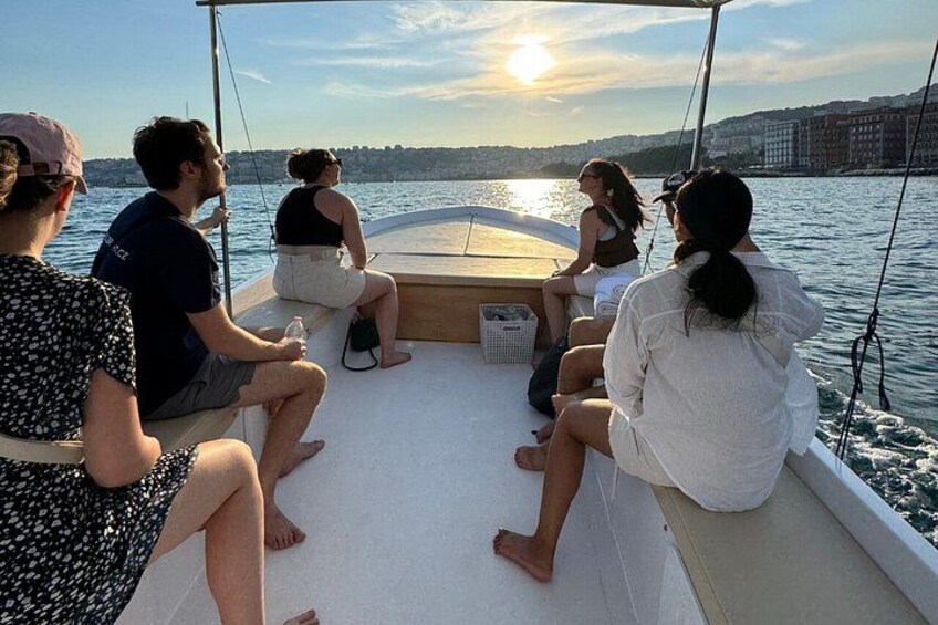 A group of people on a boat with a city skyline in the background. 3
